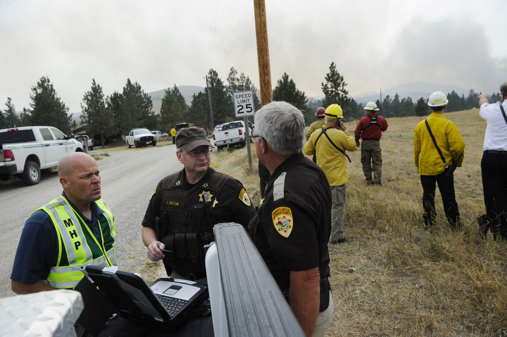 From left, Jay Nelson of the Montana Highway Patrol, Lewis and Clark County Sheriff Leo Dutton and Jefferson County Undersheriff Mike Johnson work on evacuation logistics Thursday afternoon.